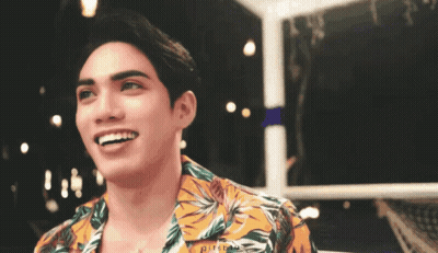 Young Man In Floral Shirt Smiling At Camera GIF