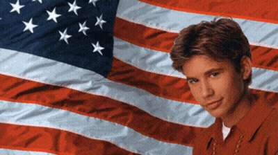Young Man In Front Of American Flag GIF