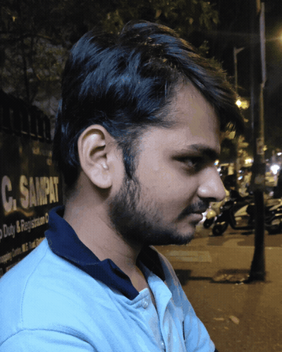 Young Man In Front Of C. Sampat Sign GIF