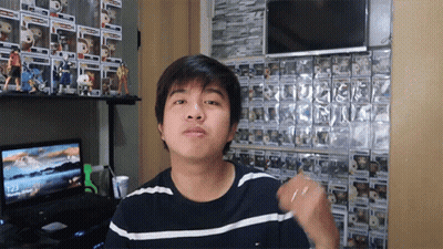 Young Man In Front Of Funko Pop Wall GIF