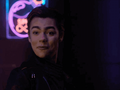 Young Man In Front Of Neon Save Sign GIF