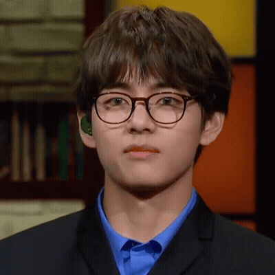 Young Man In Glasses And Blue Shirt Looking At Camera GIF
