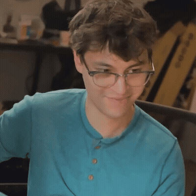 Young Man In Glasses And Blue Shirt Smiling GIF