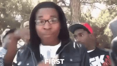 Young Man In Glasses And Hoodie Standing Before Crowd GIF