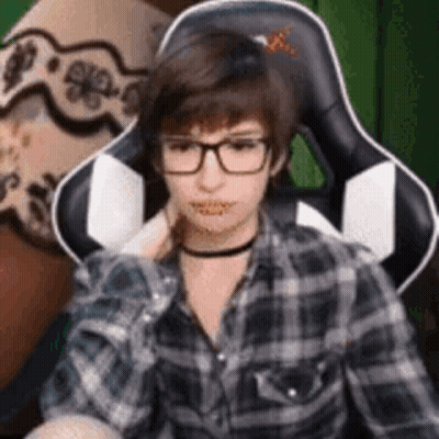 Young Man In Glasses And Plaid Shirt Sitting GIF