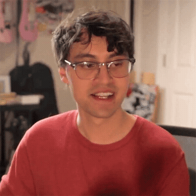 Young Man In Glasses And Red Sweater Smiling GIF