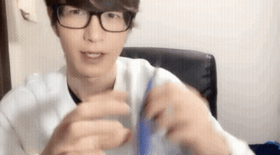 Young Man In Glasses And White Shirt Holding Blue Object GIF