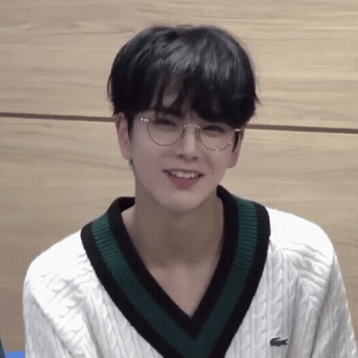 Young Man In Glasses And White Sweater With Green Collar GIF