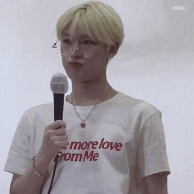 Young Man In Glasses And White T-Shirt Holding Microphone Making Face GIF