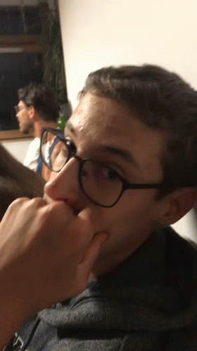 Young Man In Glasses Holding Nose GIF