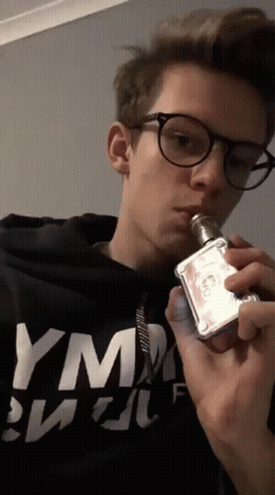 Young Man In Glasses Smoking E-Cigarette With YM Shirt GIF