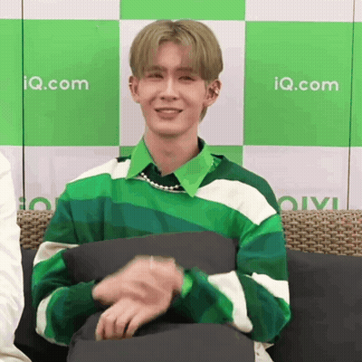 Young Man In Green And White Striped Sweater On Couch GIF