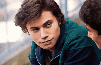Young Man In Green Jacket Close Up GIF