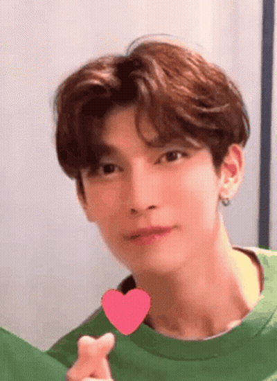 Young Man In Green Shirt Holding Heart GIF