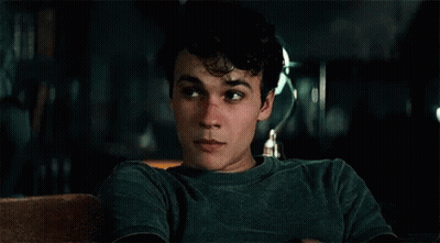 Young Man In Green Shirt Sitting On Couch Eyes Closed GIF