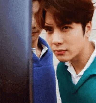 Young Man In Green Sweater Looking At Computer GIF