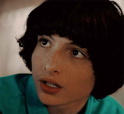 Young Man In Grey Jacket Looking At Watch GIF