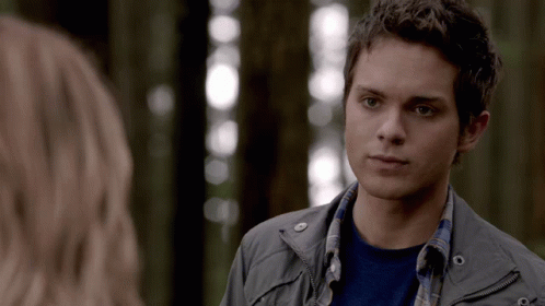 Young Man In Grey Jacket Looks At Woman GIF