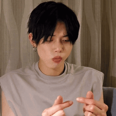 Young Man In Grey Shirt Making Heart With Fingers GIF