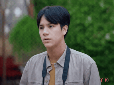 Young Man In Grey Shirt With Black Strap GIF