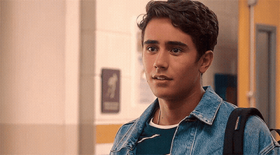 Young Man In Hallway With Backpack GIF