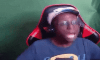 Young Man In Hat And Headphones Sitting In Chair GIF