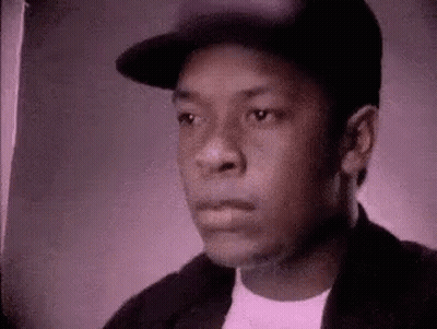 Young Man In Hat And Jacket Looking At Camera GIF