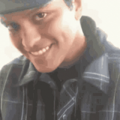 Young Man In Hat And Plaid Shirt Smiling GIF