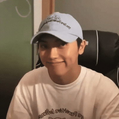 Young Man In Hat And White Shirt Smiling GIF