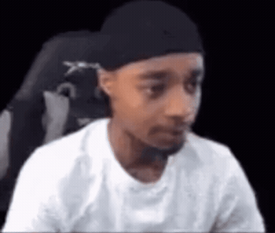 Young Man In Hat Sitting GIF