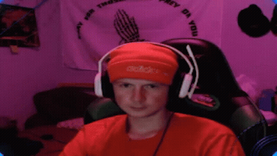 Young Man In Headphones And Orange Beanie Sitting In Chair GIF