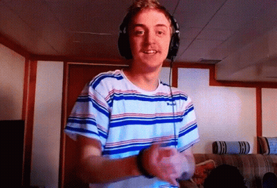 Young Man In Headphones And Striped Shirt Smiling GIF