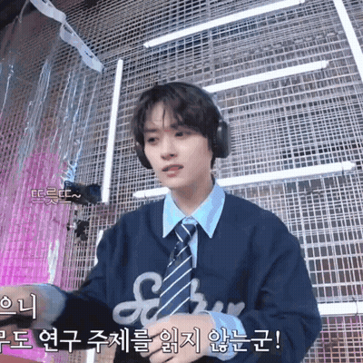 Young Man In Headphones And Tie At Microphone GIF