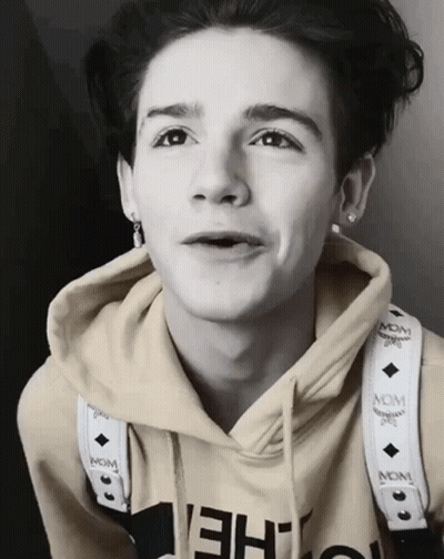Young Man In McM Hoodie With Neck Strap GIF