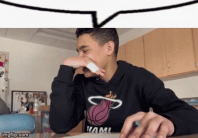 Young Man In Miami Heat Sweatshirt Covering Nose GIF