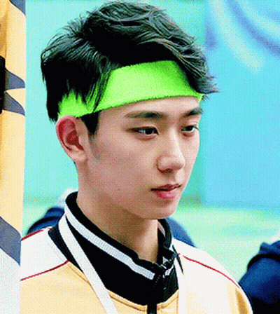 Young Man In Neon Green Headband Looking At Camera GIF