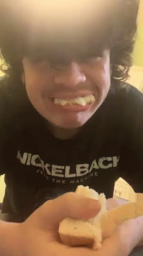 Young Man In Nickelback Shirt Holding Bread GIF