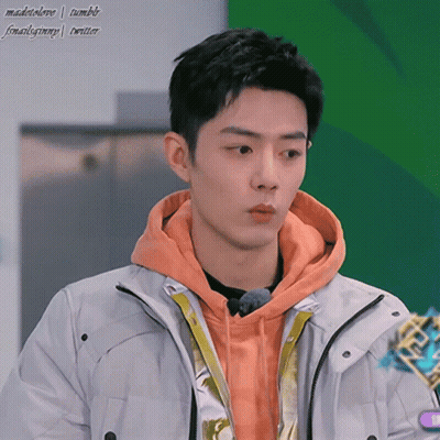 Young Man In Orange Hoodie And White Jacket GIF