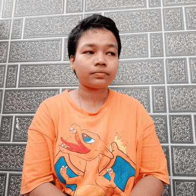 Young Man In Orange Shirt With Cartoon Character GIF