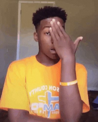 Young Man In Orange T-Shirt Covering Face GIF