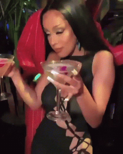 Young Man In Pink And Blue Jacket With Letter T Drinking GIF