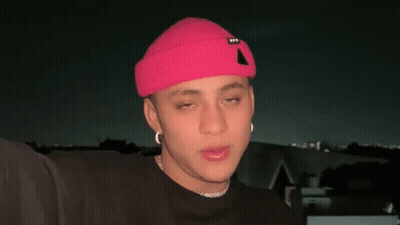 Young Man In Pink Hat And Black Shirt GIF