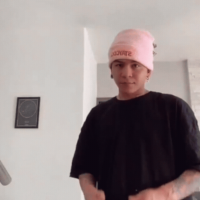 Young Man In Pink Hat And Black Shirt GIF