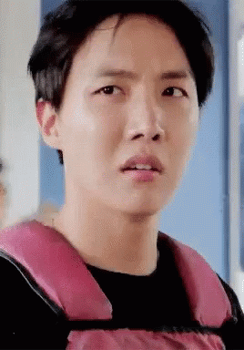 Young Man in Pink Life Vest Making Funny Face