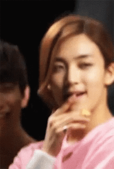Young Man In Pink Shirt Eating Lemon Slice GIF