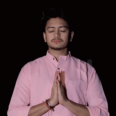 Young Man In Pink Shirt Praying With Eyes Closed GIF