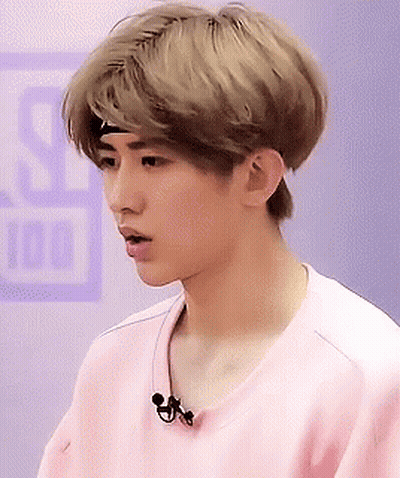 Young Man In Pink Shirt With Headband And Microphone GIF