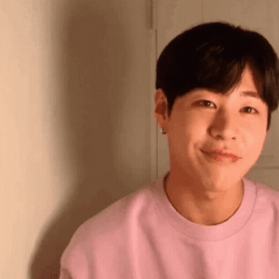Young Man In Pink Sweater Smiling GIF