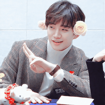 Young Man In Plaid Jacket With Flower In Ear GIF