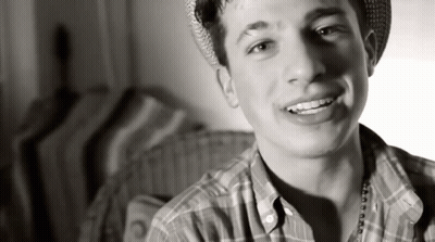 Young Man In Plaid Shirt And Hat Smiling GIF